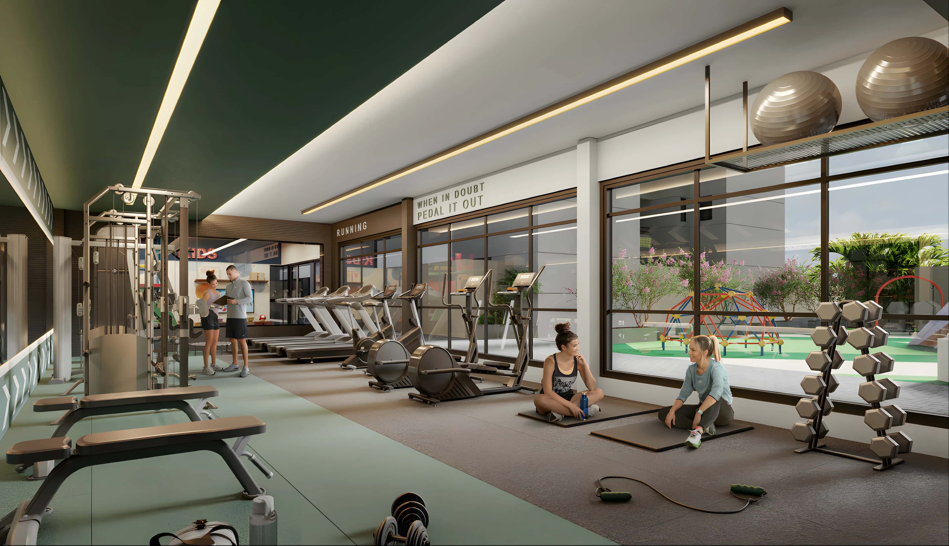 Academia do Next Home com esteiras, halteres e vidro com vista para o playground