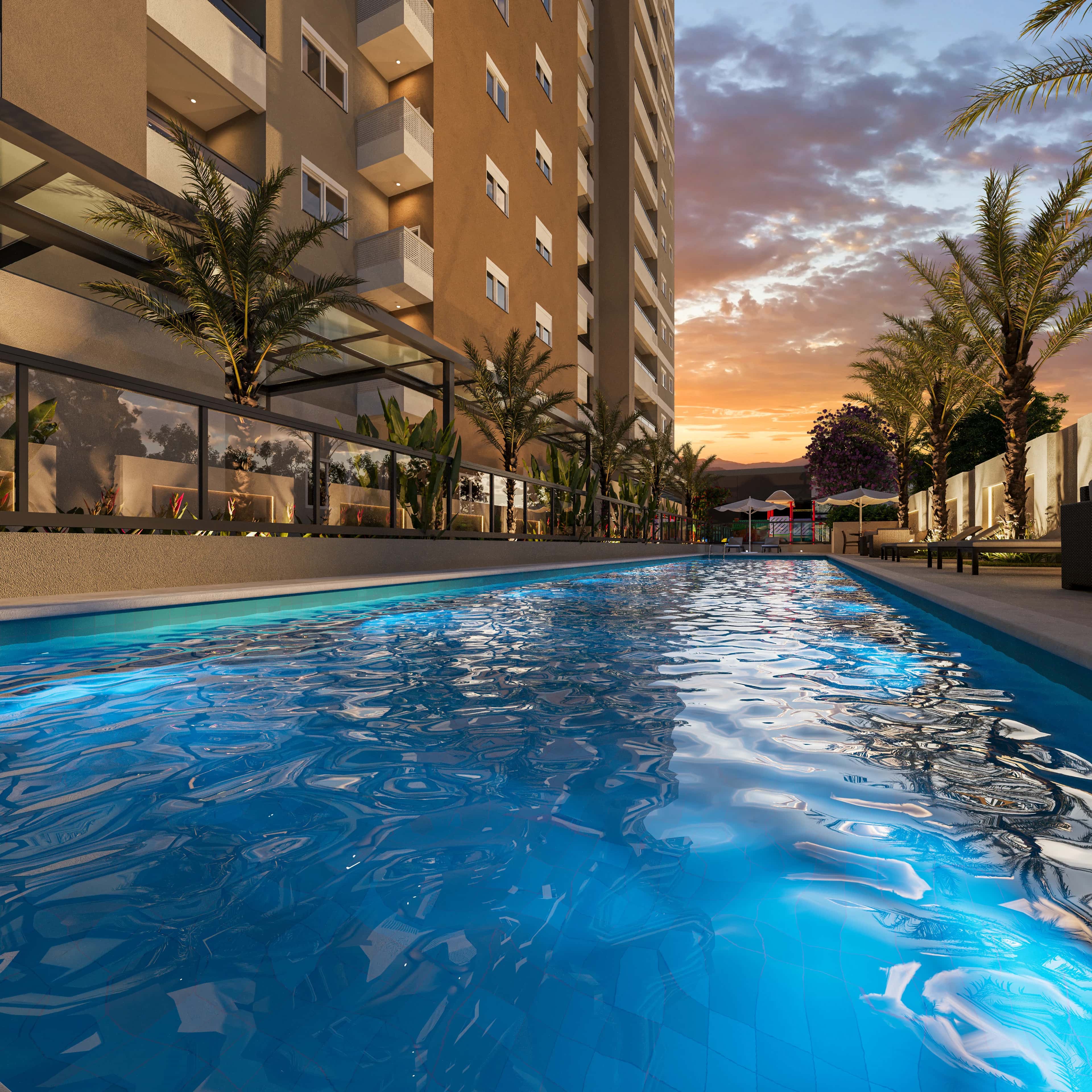 Piscina adulto do Sky Breeze ao entardecer, com palmeiras e a torre ao fundo