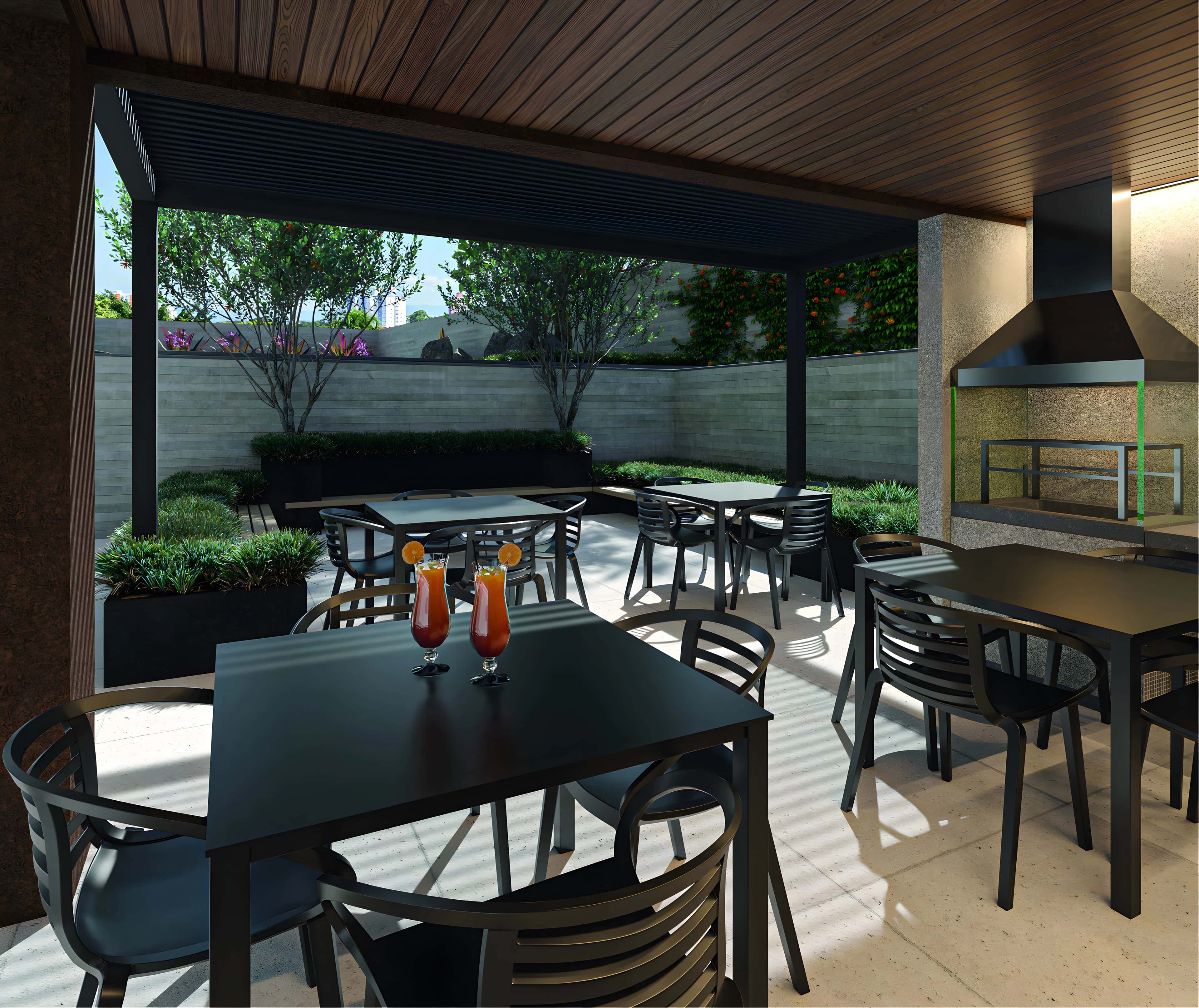 Espaço gourmet externo do Speciale com mesas e churrasqueira